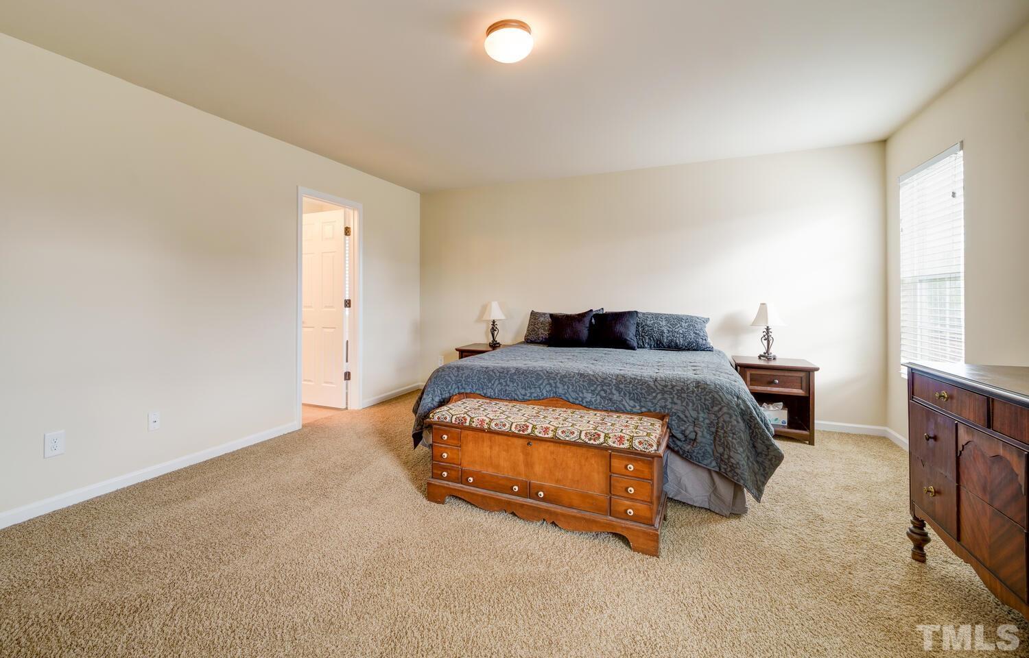 4104 Burnaby Street Raleigh, NC 27616 - Photo 22 of 59 a bedroom with a bed and a window