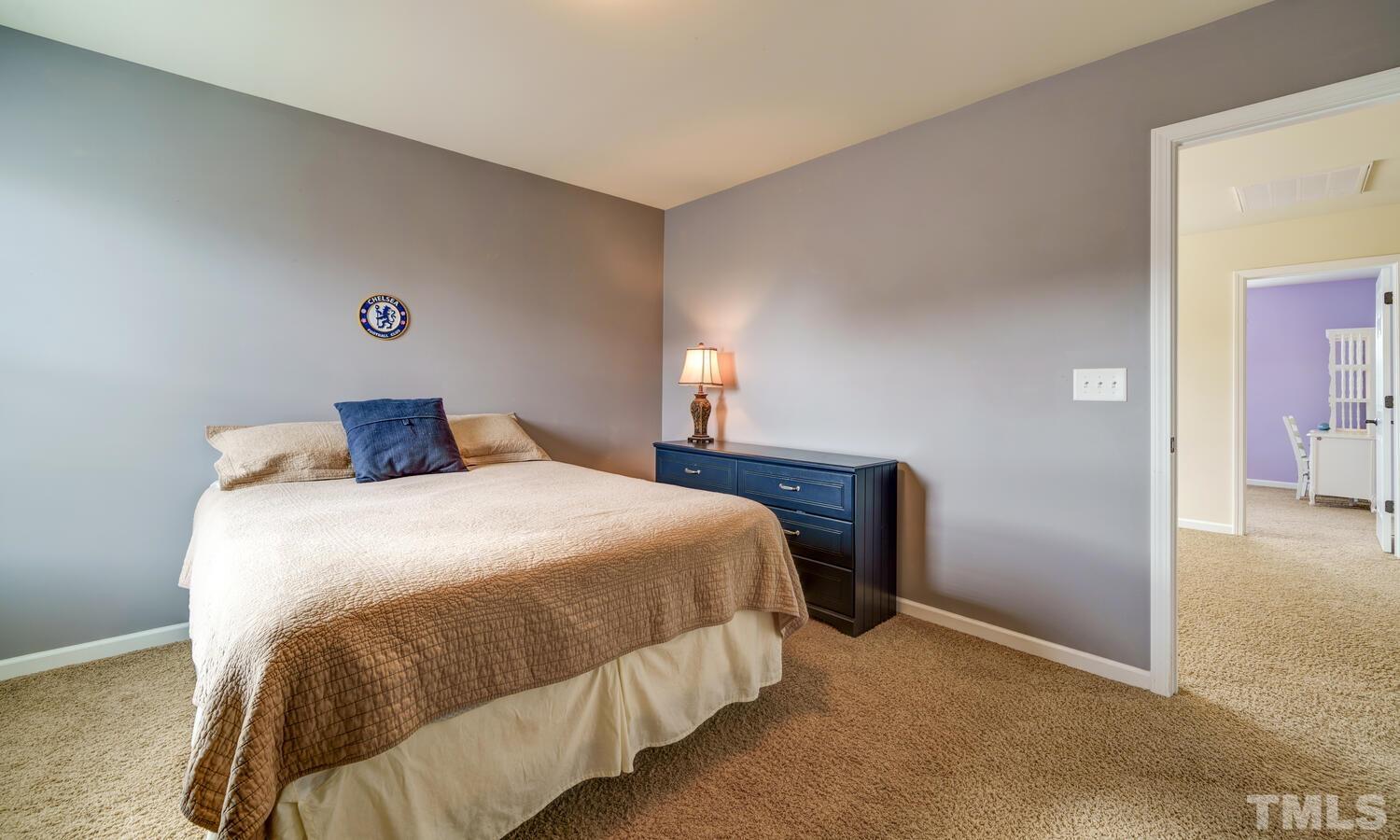 4104 Burnaby Street Raleigh, NC 27616 - Photo 27 of 59 a bedroom with a bed and wooden floor