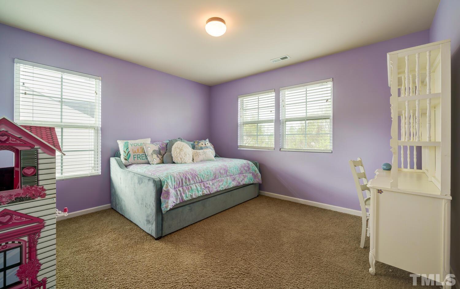 4104 Burnaby Street Raleigh, NC 27616 - Photo 29 of 59 a bedroom with a bed and a window