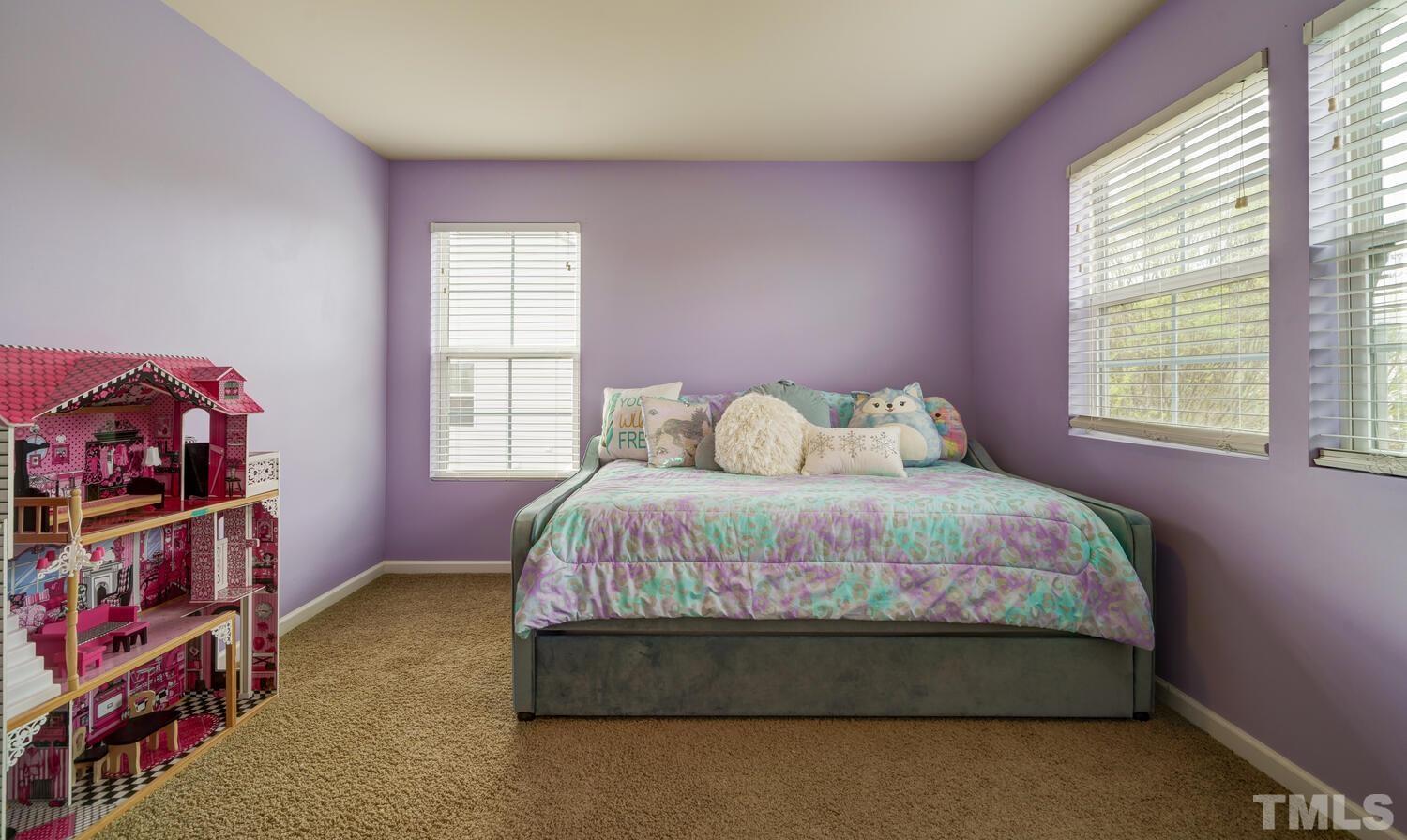 4104 Burnaby Street Raleigh, NC 27616 - Photo 30 of 59 a bedroom with a bed a dresser and a window