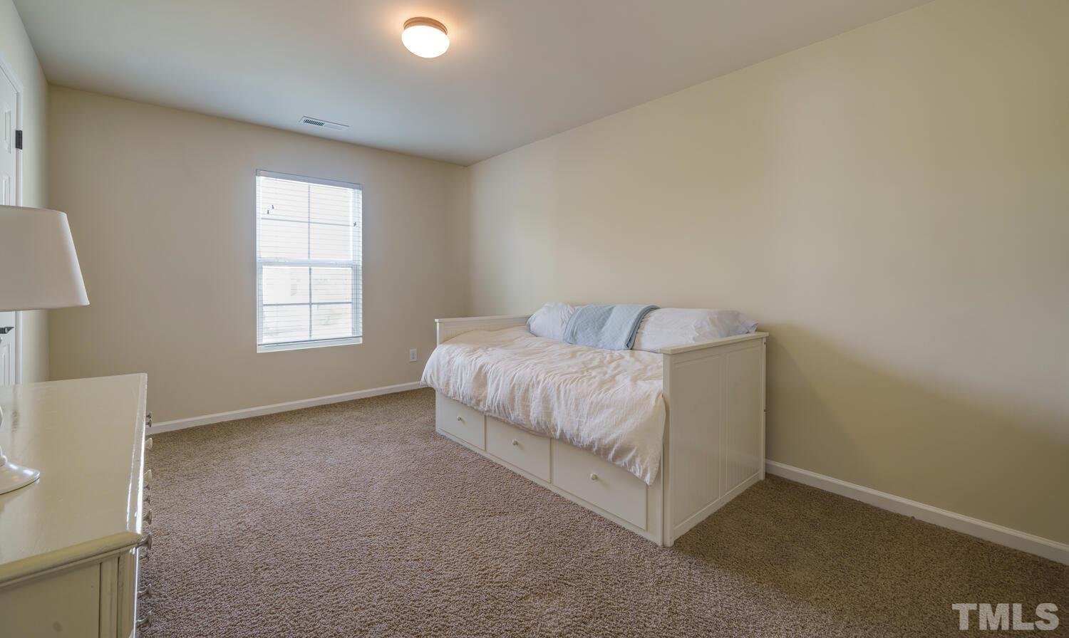4104 Burnaby Street Raleigh, NC 27616 - Photo 31 of 59 a room with a bed and a window
