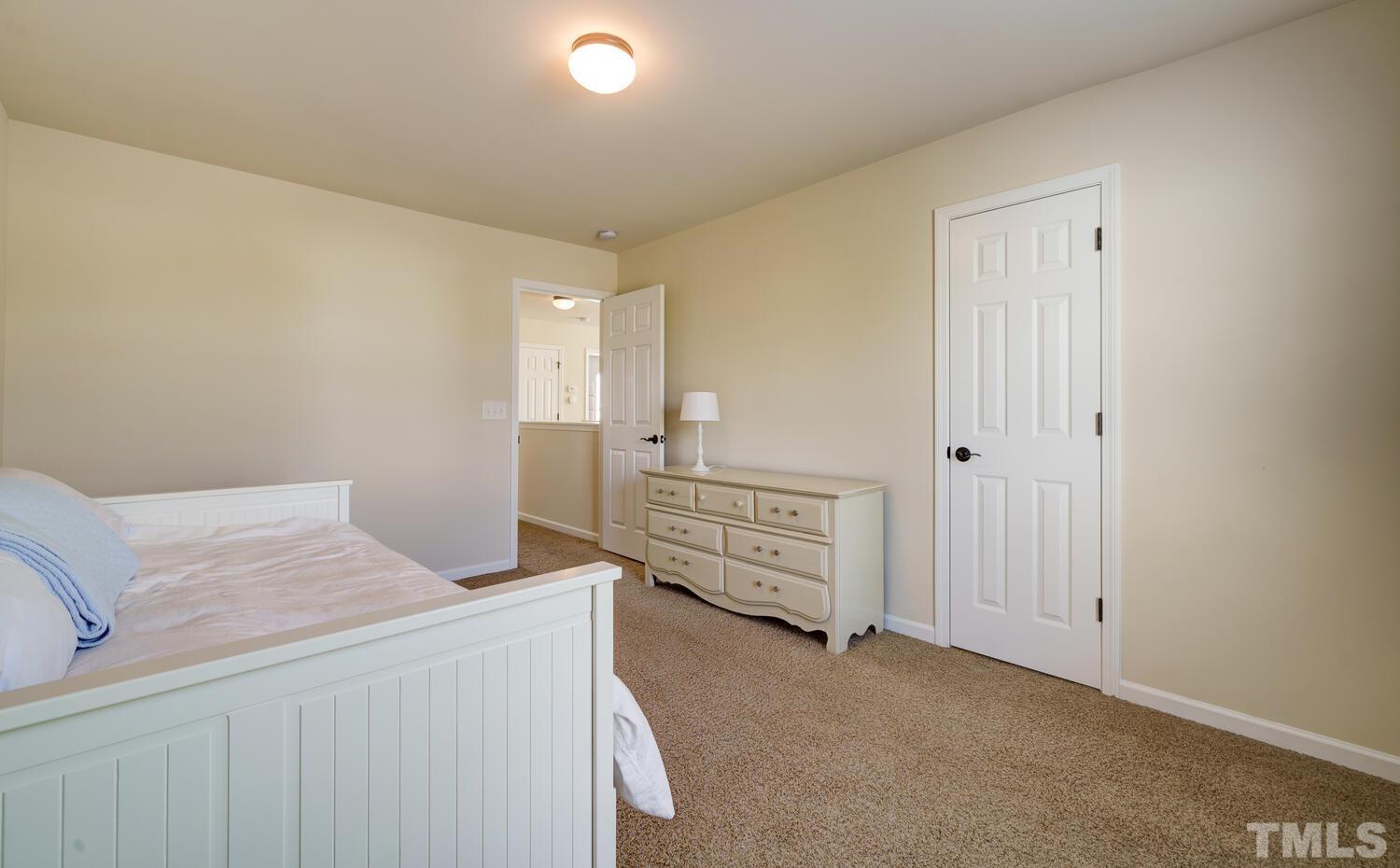 4104 Burnaby Street Raleigh, NC 27616 - Photo 32 of 59 a bedroom with a bed and a cabinets
