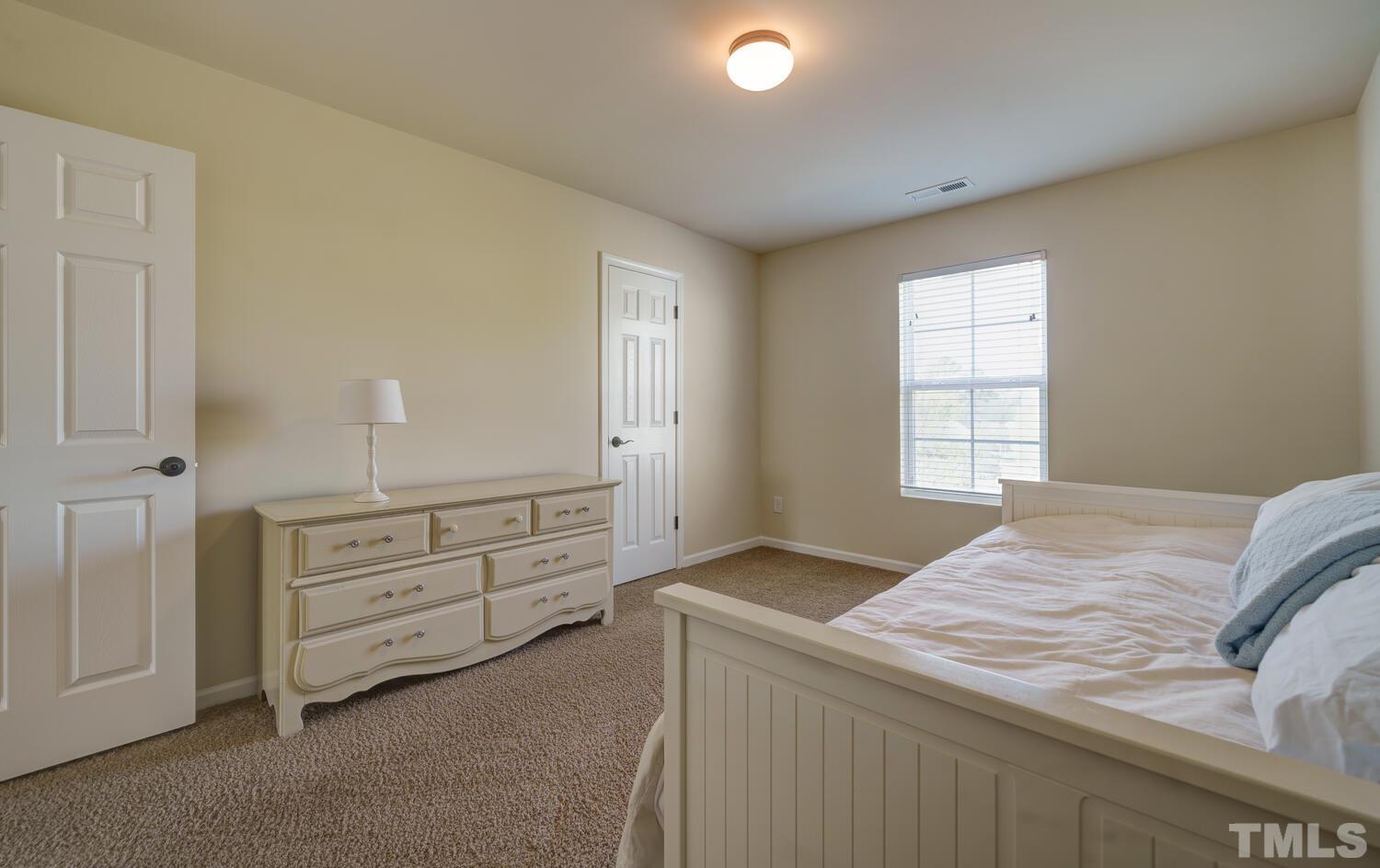 4104 Burnaby Street Raleigh, NC 27616 - Photo 33 of 59 a bed room with a bed and a window