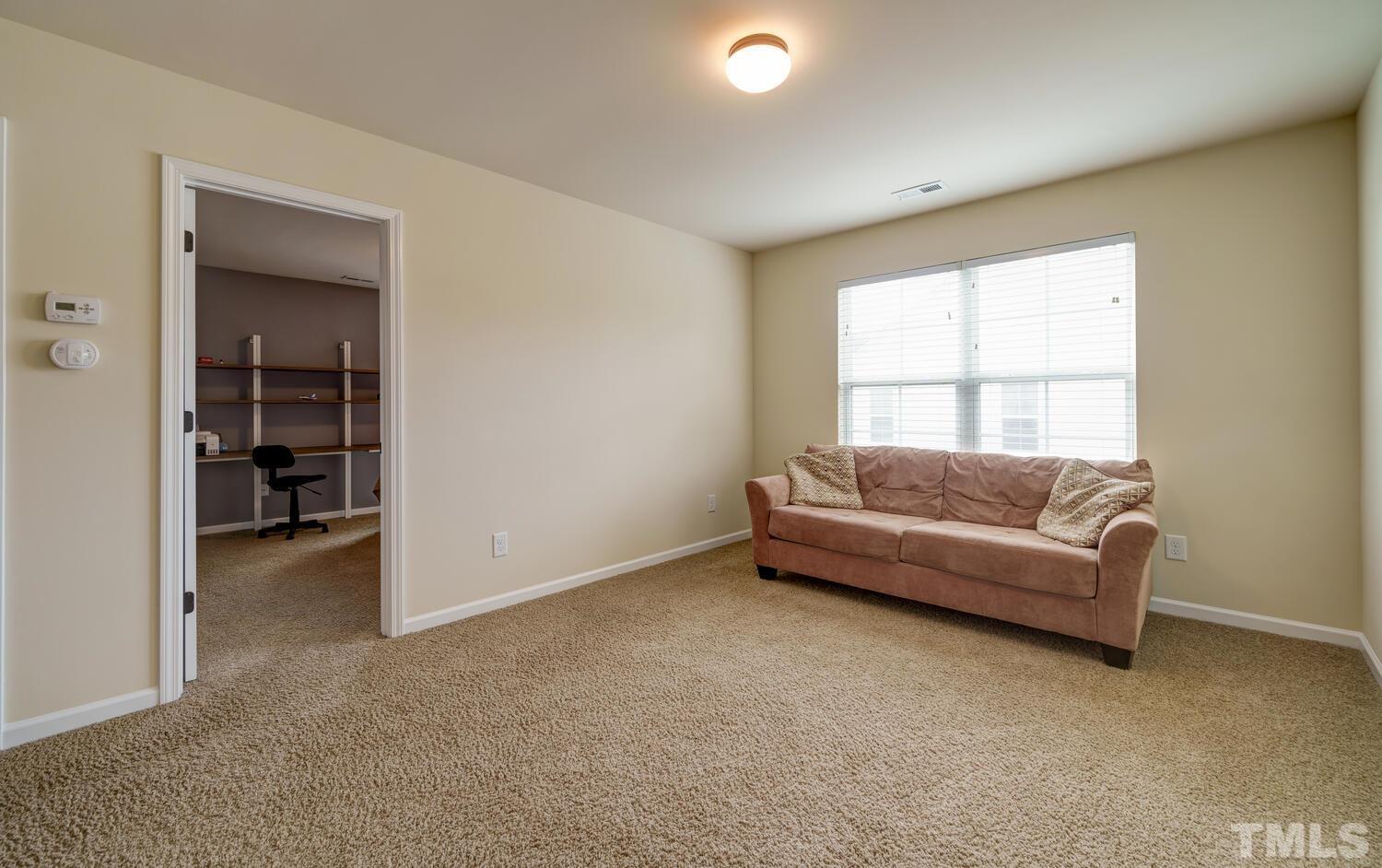 4104 Burnaby Street Raleigh, NC 27616 - Photo 34 of 59 a living room with furniture and a window