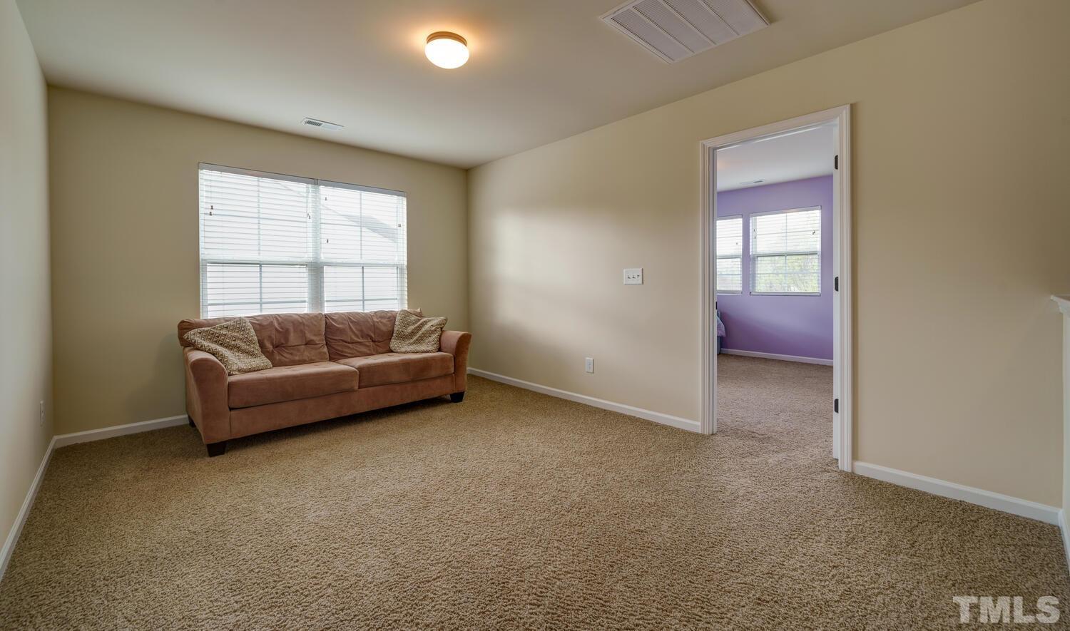 4104 Burnaby Street Raleigh, NC 27616 - Photo 36 of 59 a living room with furniture and a window