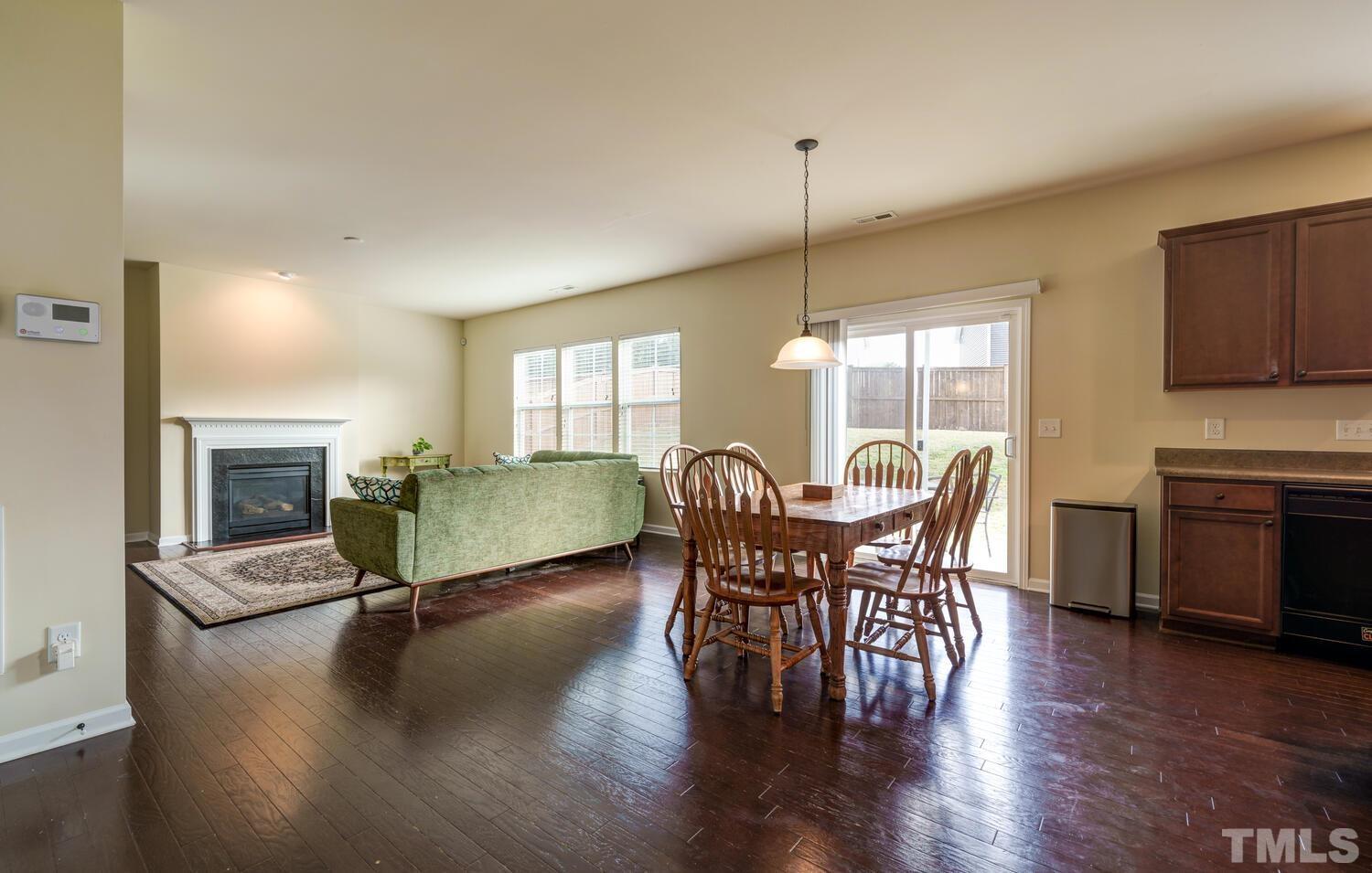 4104 Burnaby Street Raleigh, NC 27616 - Photo 8 of 59 a view of a dining room with furniture window and wooden floor
