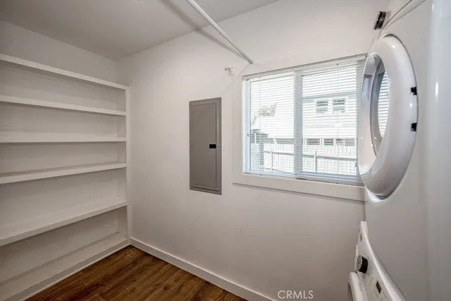 a room with wooden floor and a window