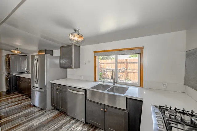 a kitchen with stainless steel appliances a refrigerator and a stove