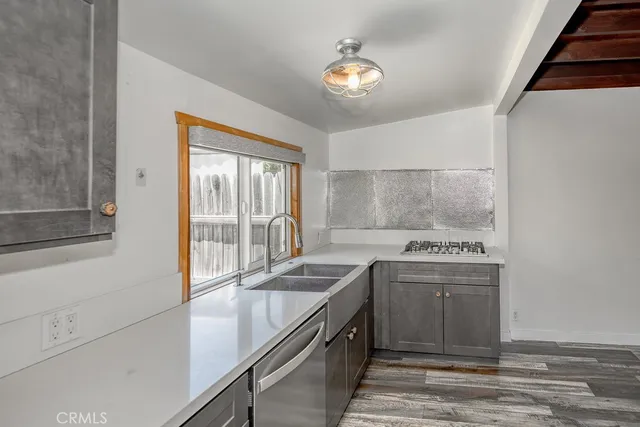 a kitchen with a sink stove and cabinets