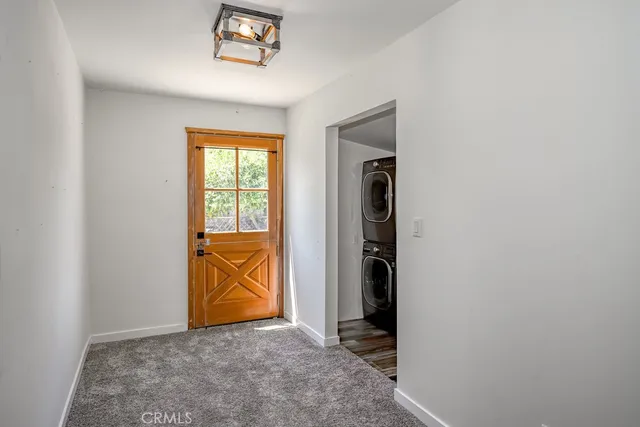 an empty room with an entryway and wooden floor