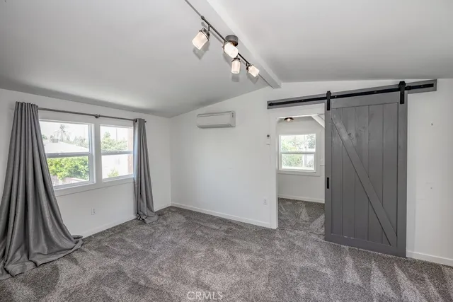 a view of empty room with closet and windows