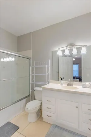 a bathroom with a toilet sink and a mirror