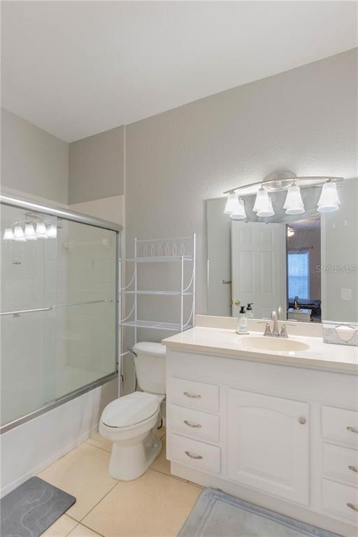 3611 Conroy Road, Unit 834 Orlando, FL 32839 - Photo 11 of 22 a bathroom with a toilet sink and a mirror