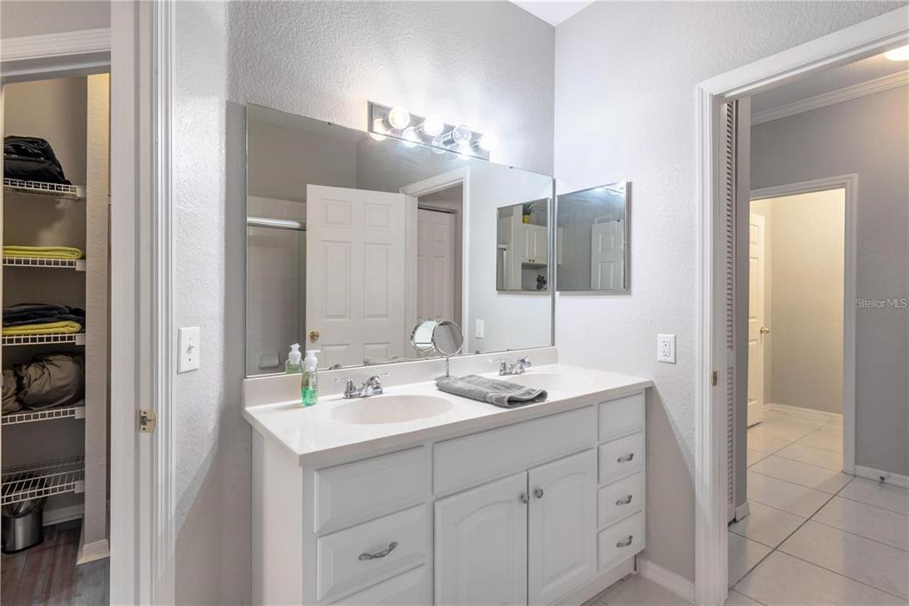 3611 Conroy Road, Unit 834 Orlando, FL 32839 - Photo 13 of 22 a bathroom with a double vanity sink and mirror