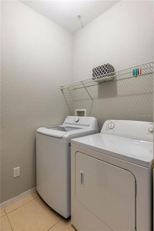 3611 Conroy Road, Unit 834 Orlando, FL 32839 - Photo 14 of 22 a utility room with dryer and washer