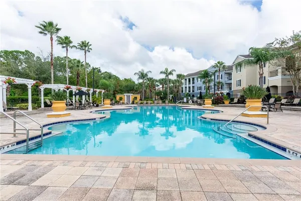 an outdoor space with swimming pool and furniture