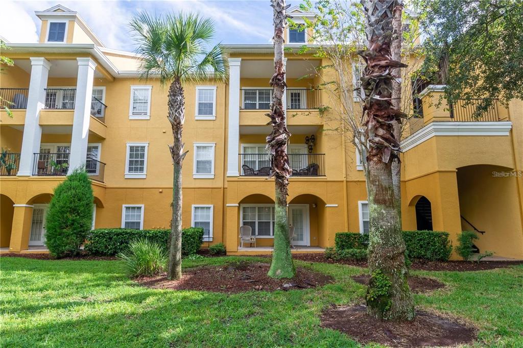 3611 Conroy Road, Unit 834 Orlando, FL 32839 - Photo 22 of 22 a view of a brick building next to a yard