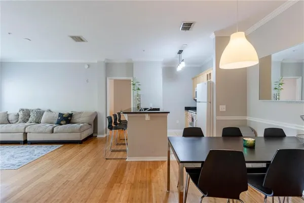 a view of a dining room with furniture and wooden floor