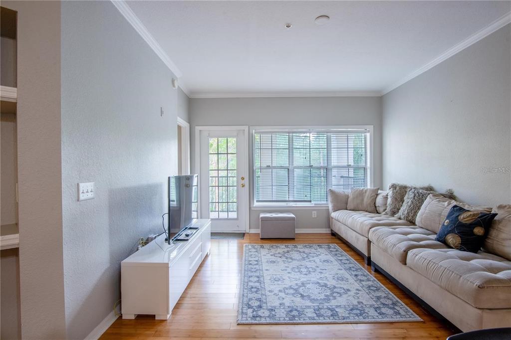 3611 Conroy Road, Unit 834 Orlando, FL 32839 - Photo 5 of 22 a living room with furniture and a large window