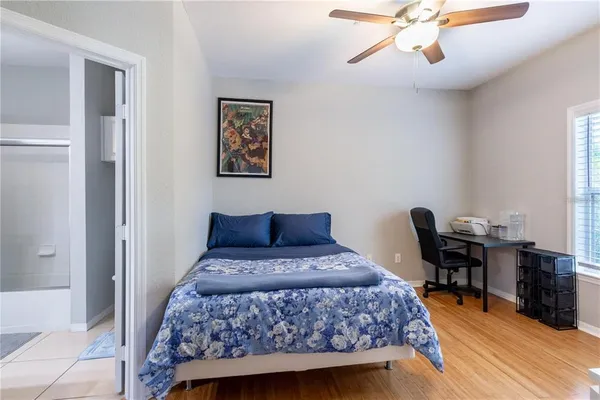 a bedroom with a bed and wooden floor