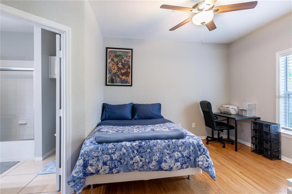 3611 Conroy Road, Unit 834 Orlando, FL 32839 - Photo 8 of 22 a bedroom with a bed and wooden floor