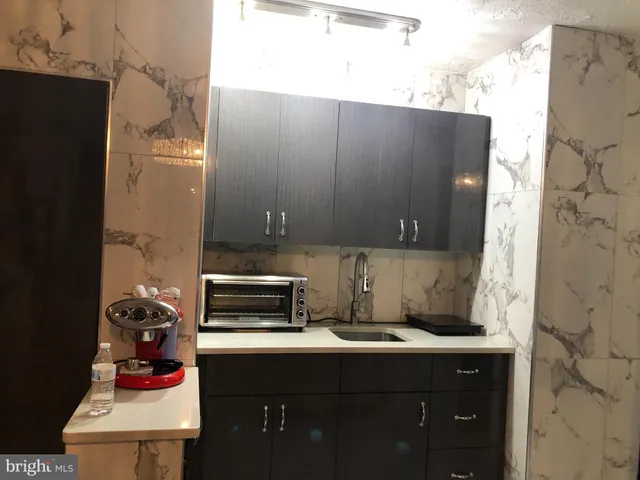 a kitchen with a sink and cabinets