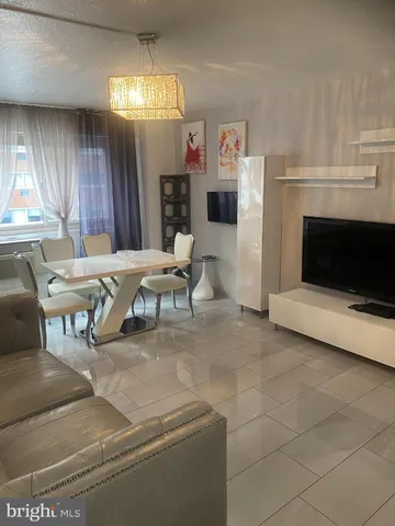 a living room with stainless steel appliances kitchen island granite countertop furniture and a kitchen view