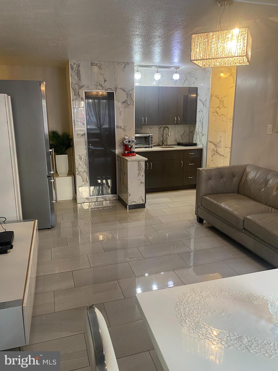2101 Chestnut Street, Unit 519 Philadelphia, PA 19103 - Photo 17 of 21 a living room with stainless steel appliances kitchen island granite countertop furniture and a kitchen view