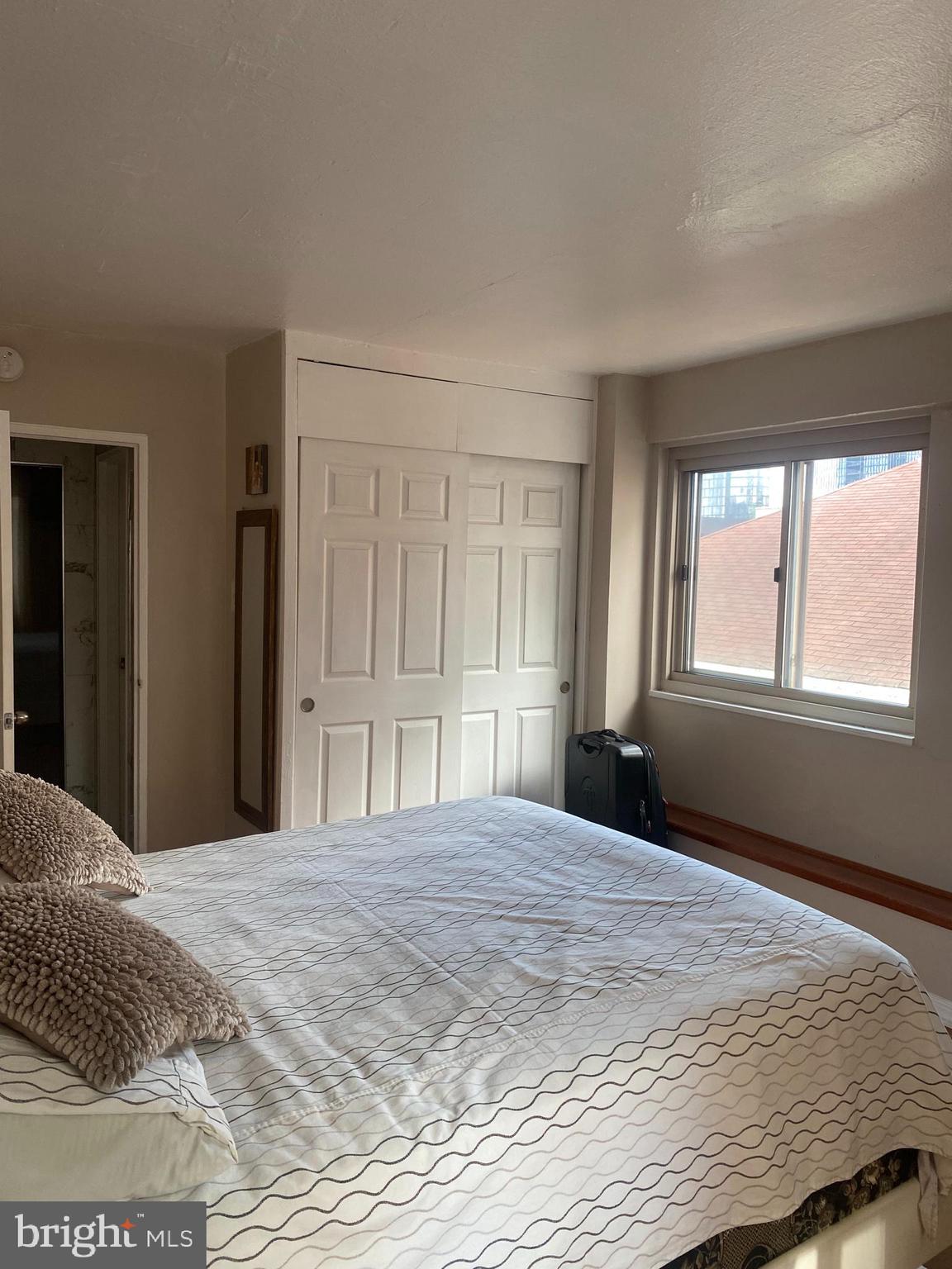 2101 Chestnut Street, Unit 519 Philadelphia, PA 19103 - Photo 21 of 21 a bedroom with a bed and a window