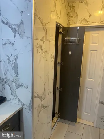 a bathroom with a shower and a sink