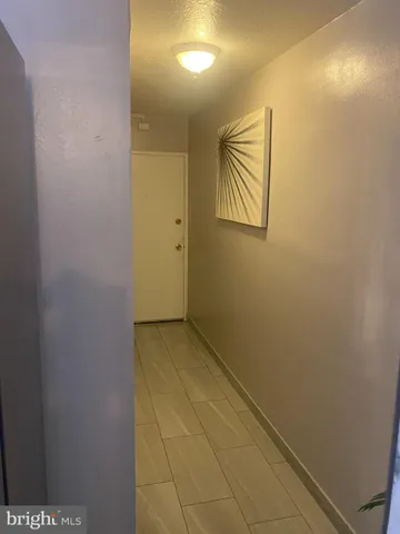 a view of hallway with paintings on the wall