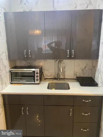 a bathroom with a shower and a sink