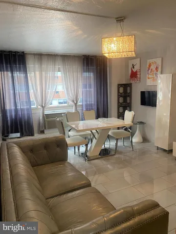 a living room with furniture and a glass door