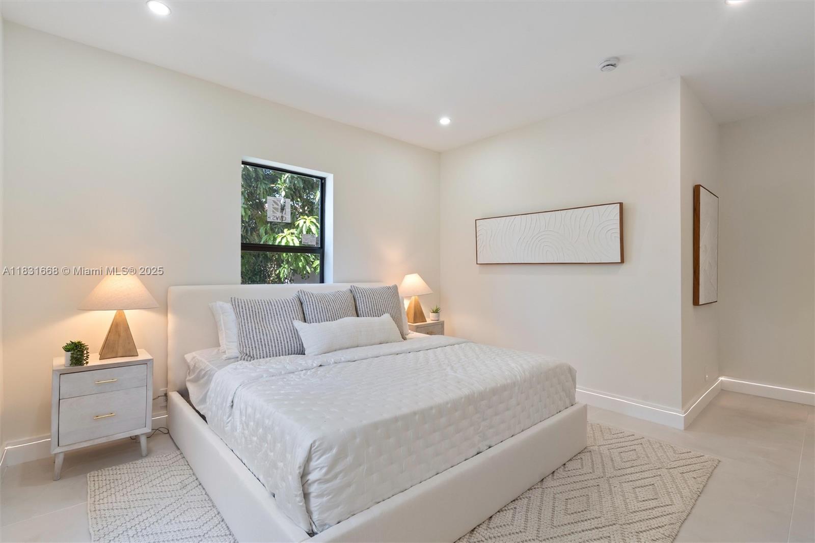 1108 Harrison Street Hollywood, FL 33019 - Photo 11 of 19 a bedroom with a bed and a lamp