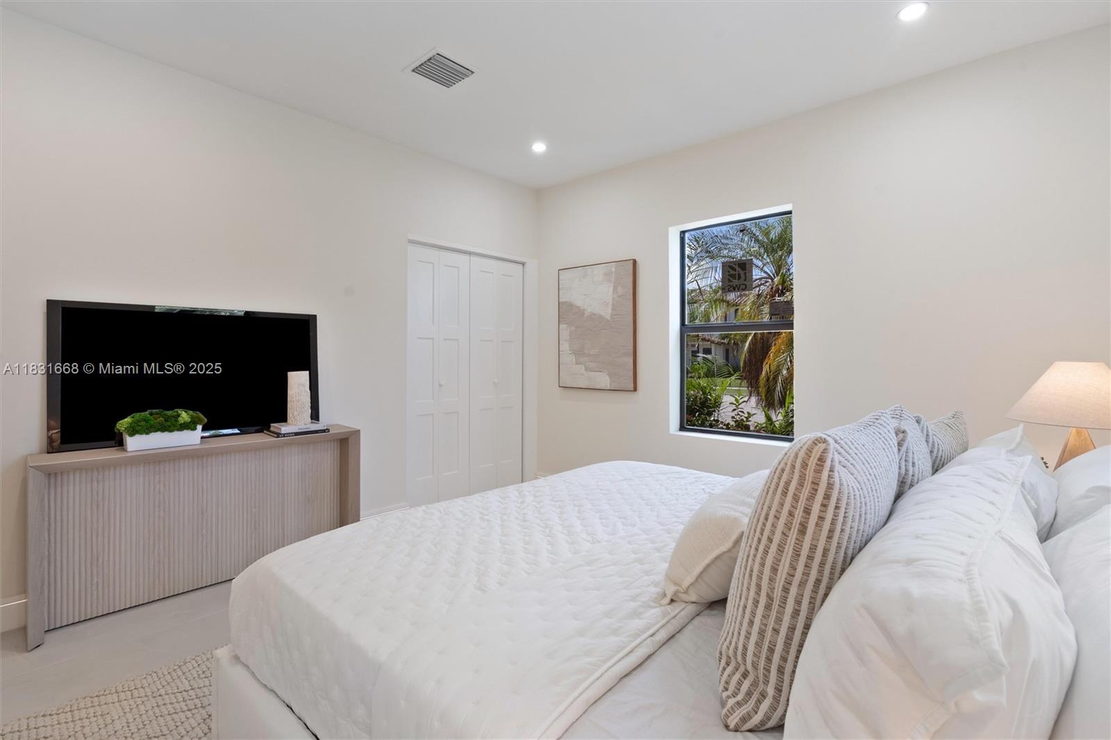 1108 Harrison Street Hollywood, FL 33019 - Photo 15 of 19 a bedroom with a bed and a television