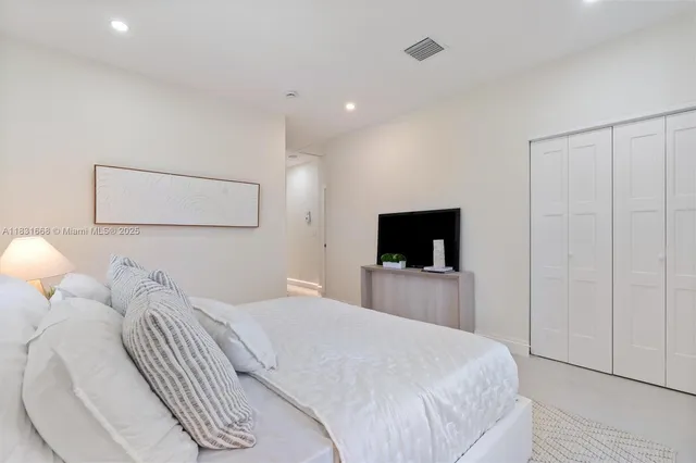 a bedroom with a bed and a television