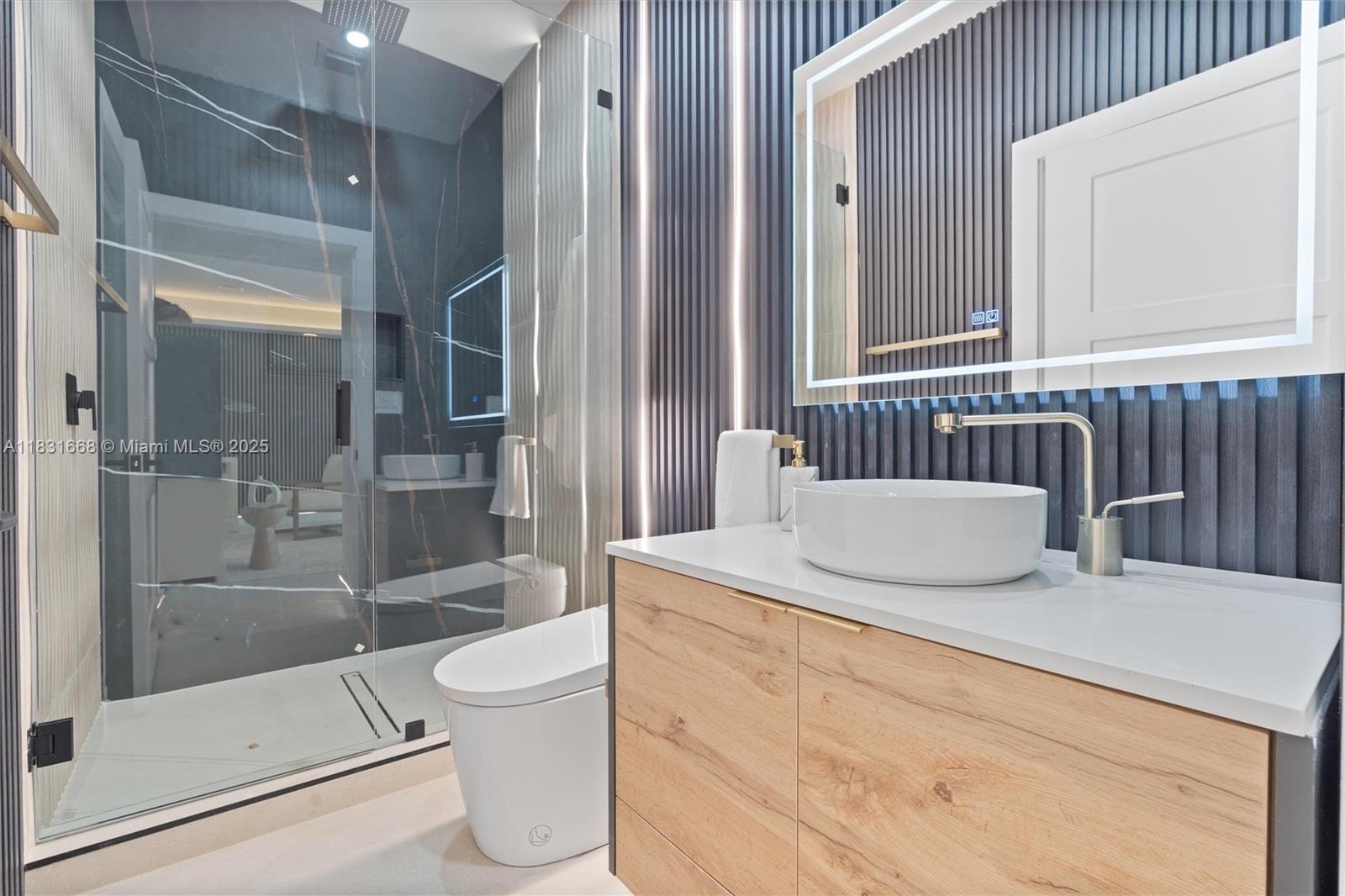 1108 Harrison Street Hollywood, FL 33019 - Photo 18 of 19 a bathroom with a granite countertop sink a toilet and shower