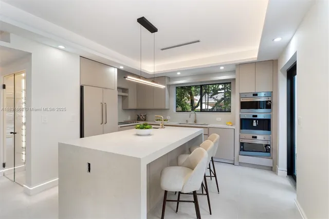 a kitchen with a table chairs refrigerator and cabinets