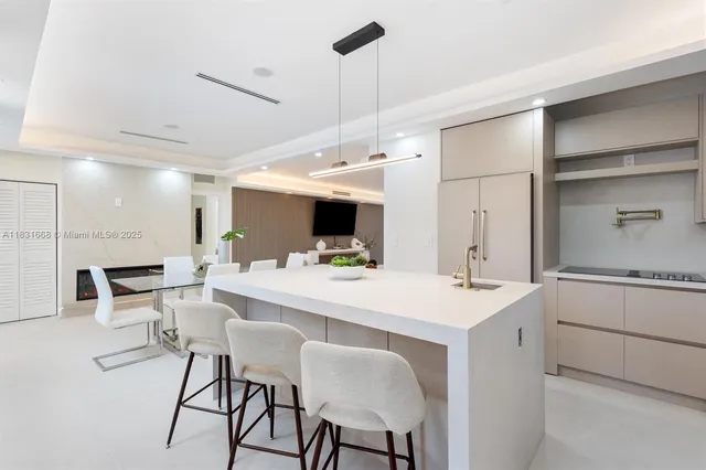 a large white kitchen with a table and chairs