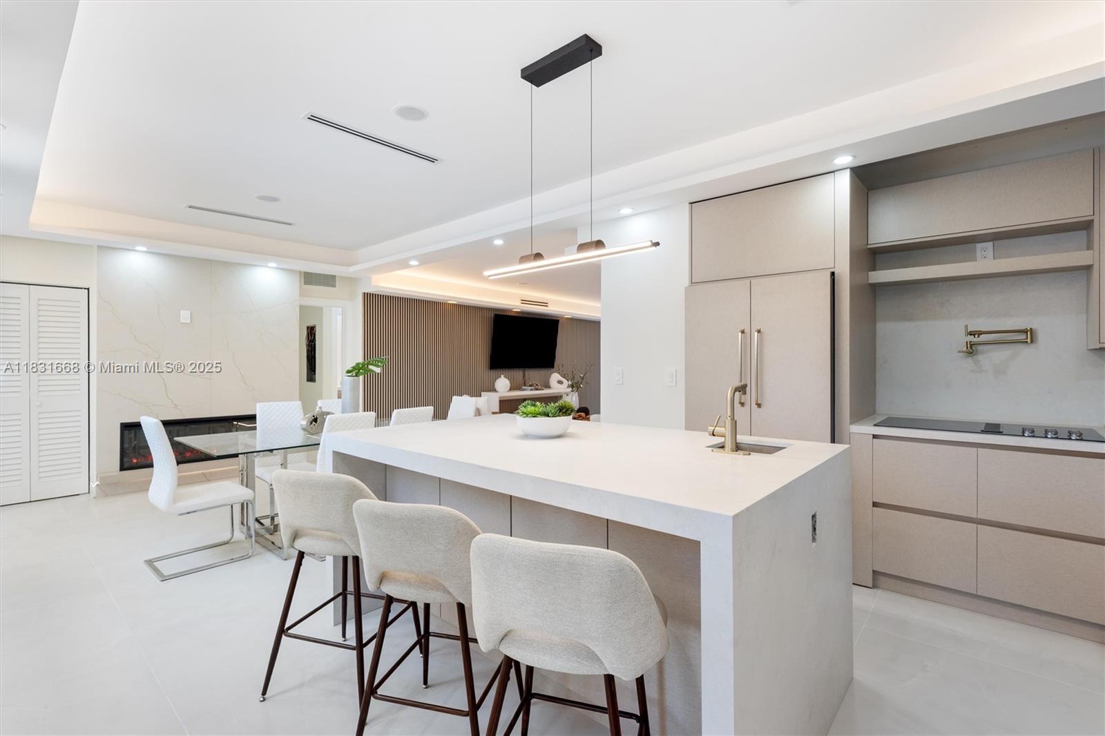 1108 Harrison Street Hollywood, FL 33019 - Photo 5 of 19 a large white kitchen with a table and chairs