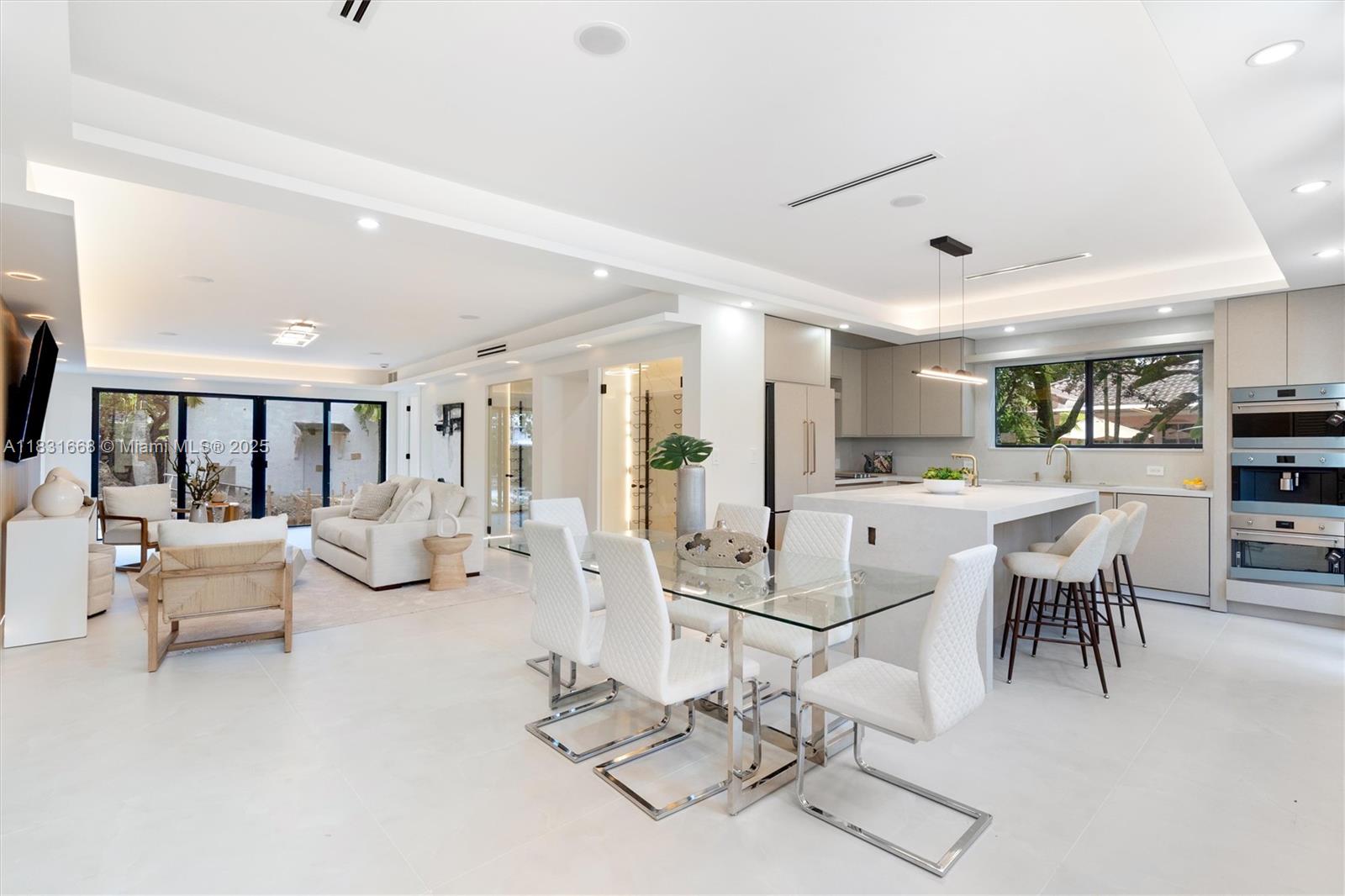 1108 Harrison Street Hollywood, FL 33019 - Photo 8 of 19 a living room with lots of white furniture and view of kitchen