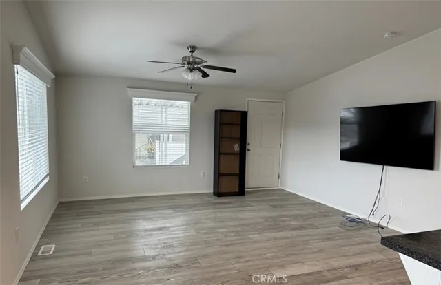 a view of a livingroom with an empty space and a window