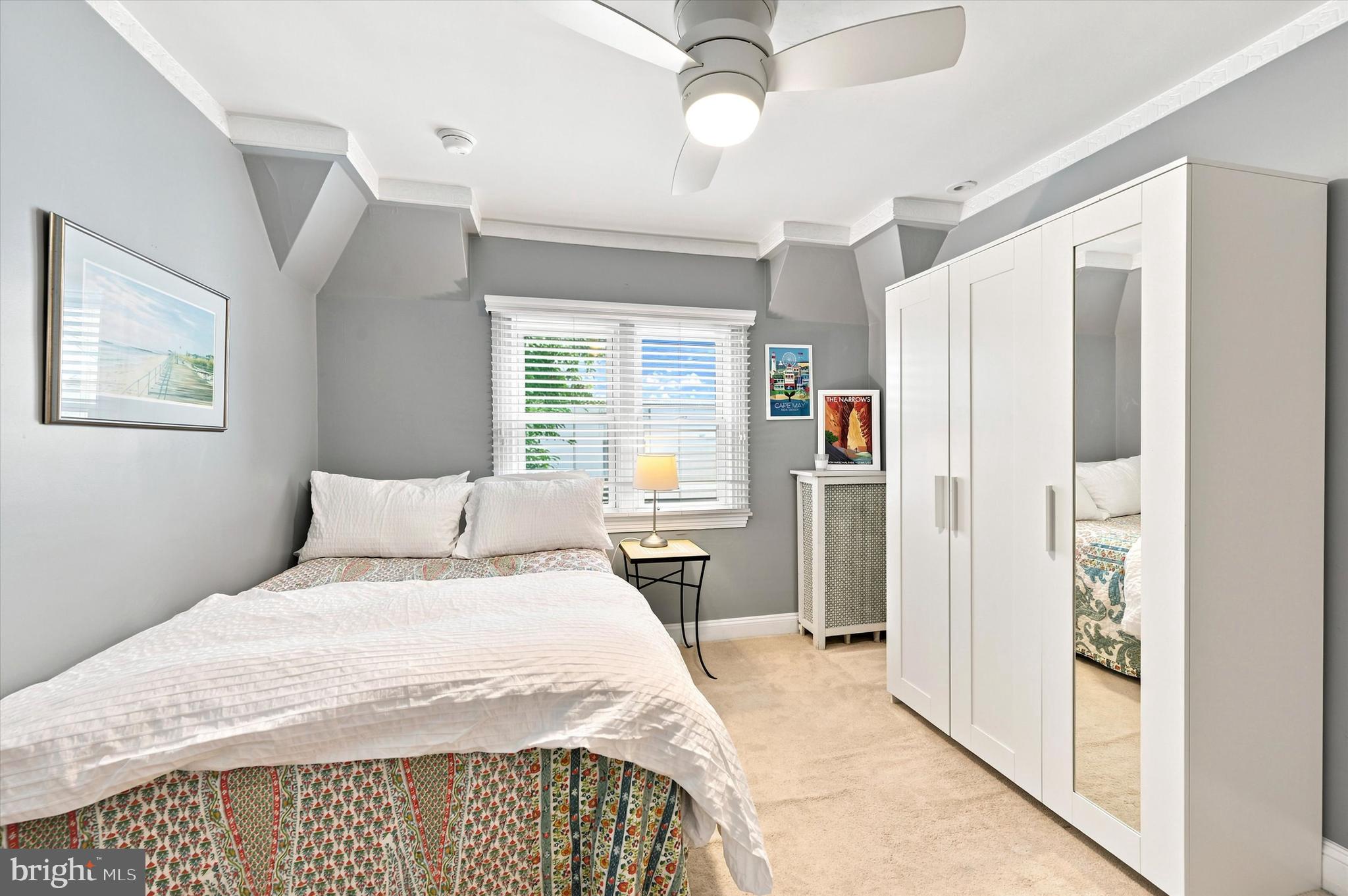 1468 Hampstead Road Wynnewood, PA 19096 - Photo 21 of 29 a bedroom with a large bed and a chandelier