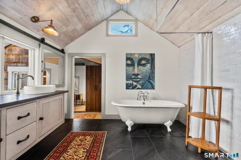 a spacious bathroom with a sink a toilet and a mirror