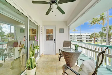 a dining room with furniture potted plants and wooden floor