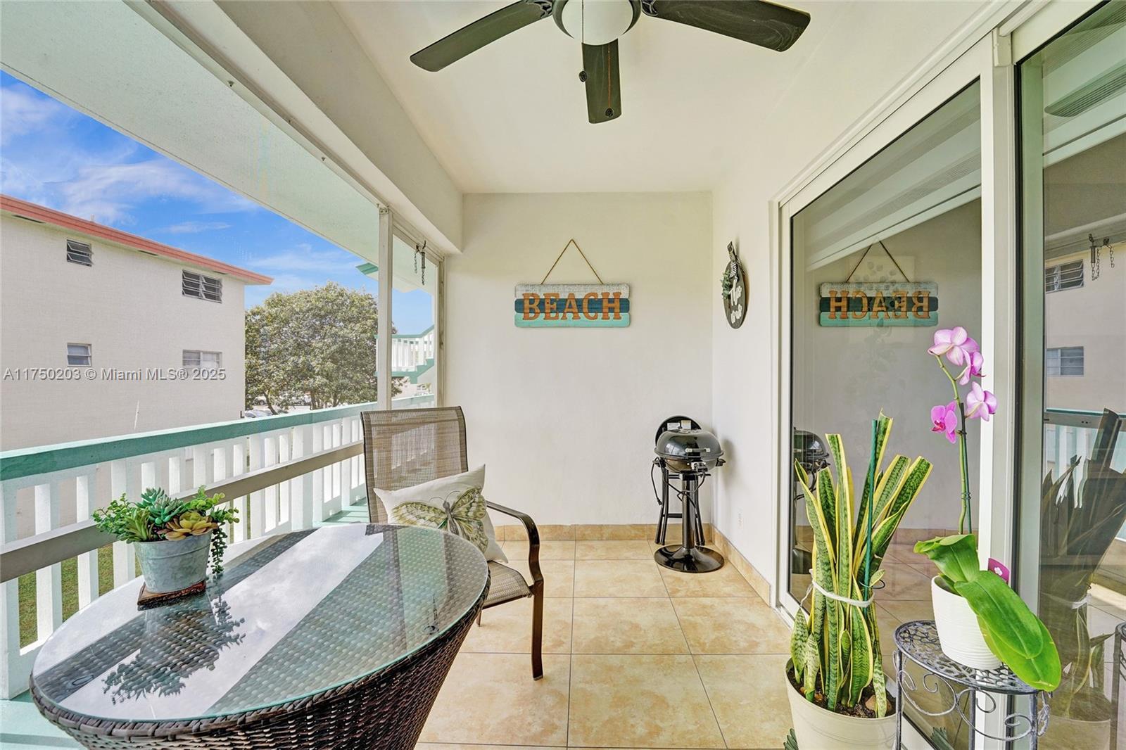 5300 Washington Street, Unit I203 Hollywood, FL 33021 - Photo 14 of 75 a dining room with furniture potted plants and wooden floor