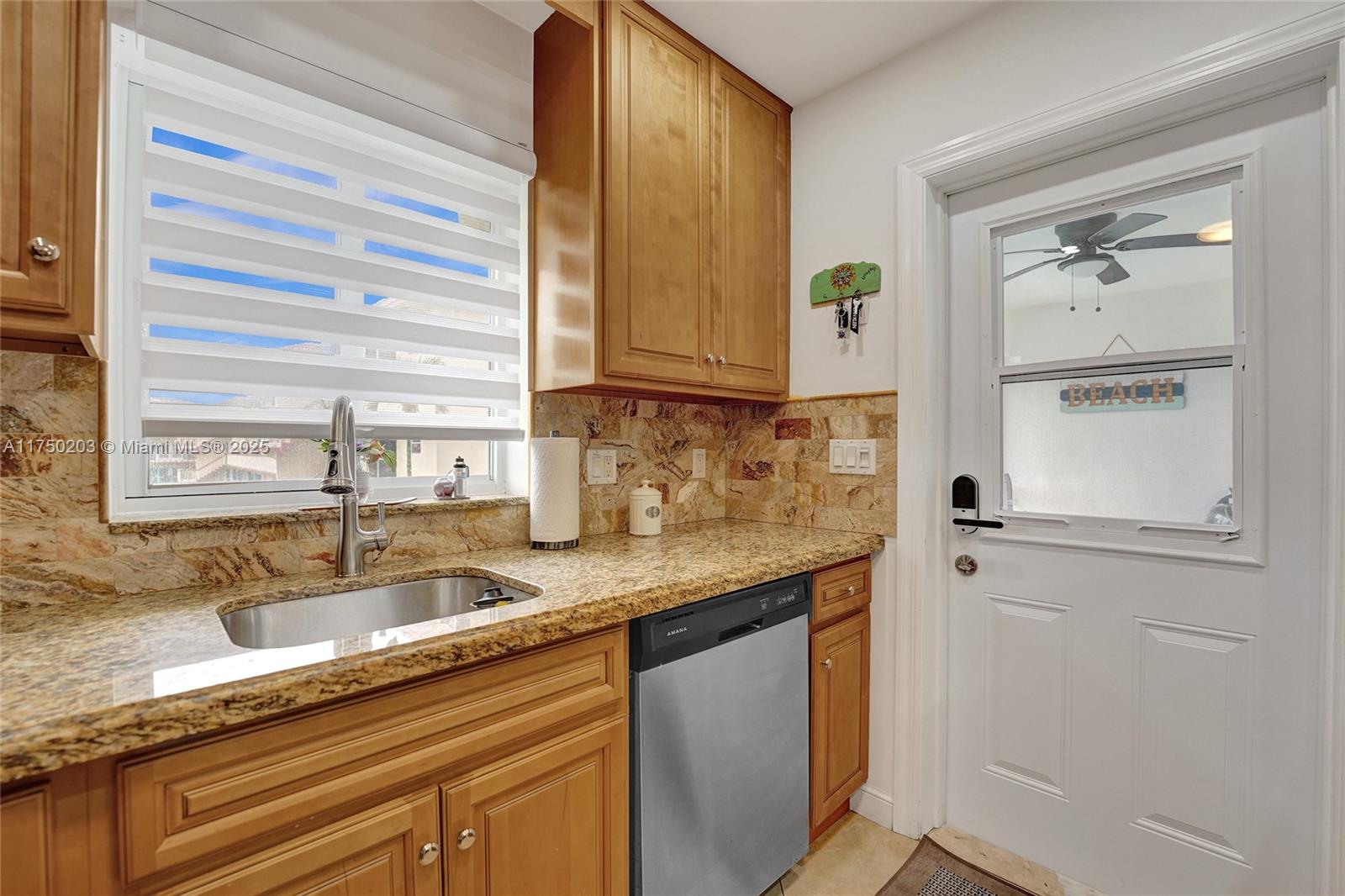 5300 Washington Street, Unit I203 Hollywood, FL 33021 - Photo 20 of 75 a kitchen with granite countertop a sink and a window