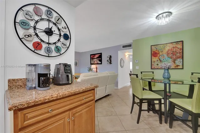a dining room with furniture and a chandelier