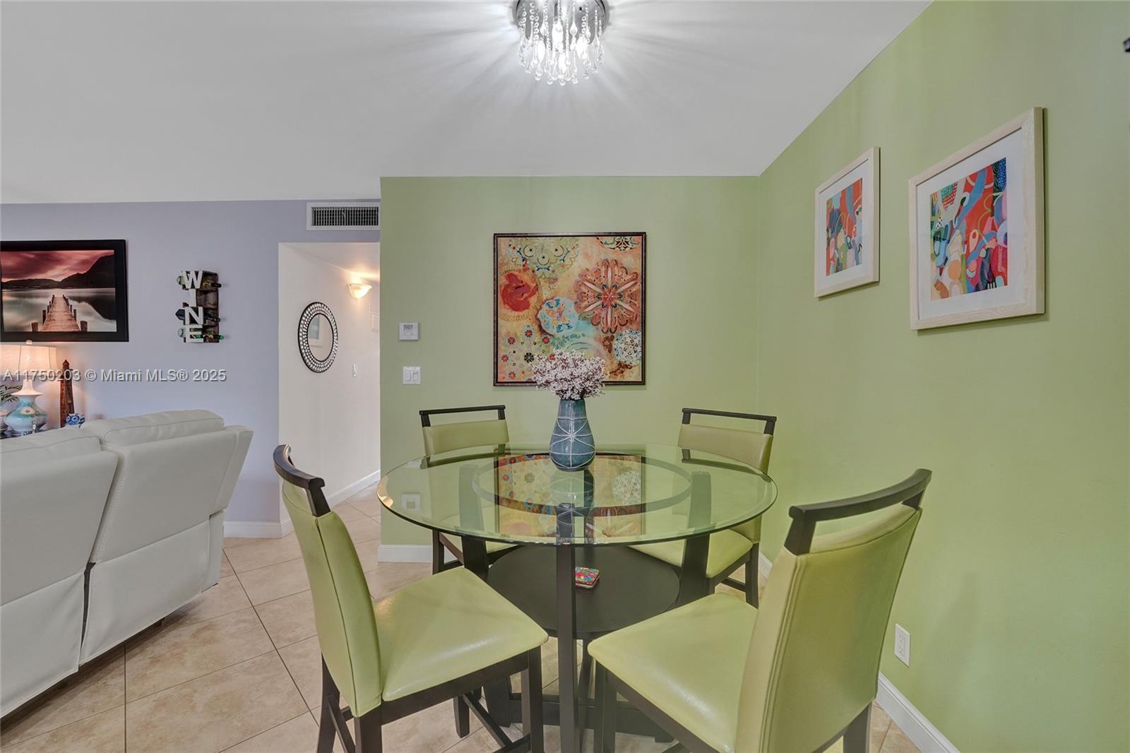 5300 Washington Street, Unit I203 Hollywood, FL 33021 - Photo 24 of 75 a dining room with furniture and a chandelier