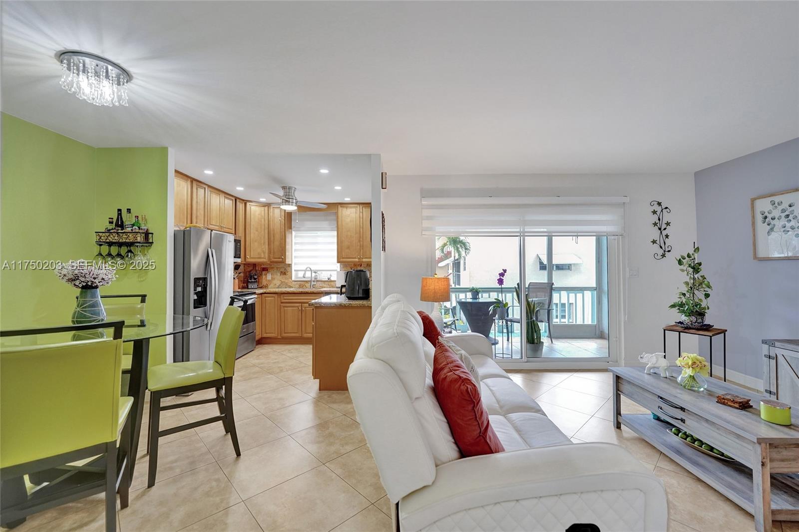 5300 Washington Street, Unit I203 Hollywood, FL 33021 - Photo 27 of 75 a living room with furniture and a dining table with kitchen view